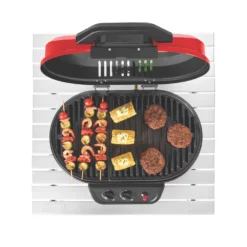 Coleman RoadTrip® 225 Portable Tabletop Propane Grill -Coleman Sales 2000033047 coleman grills 225 TT heritage red flames turned on food on grates overhead 3